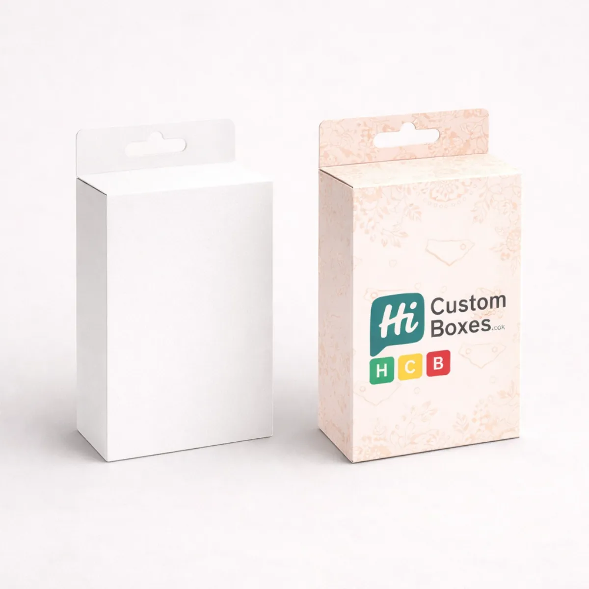 Rectangular retail boxes with euro hanging slots- featuring a clean white and a decorative pink finish- class=